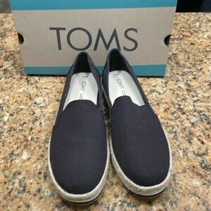 Tom’s black slip on flats.